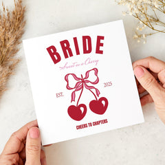 Retro Cherry Bride Design with Bows and Hearts Fun Hen Party or Bridal Celebration Card with “Cheers to Chapters” Quote Bride Card