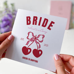 Retro Cherry Bride Design with Bows and Hearts Fun Hen Party or Bridal Celebration Card with “Cheers to Chapters” Quote Bride Card